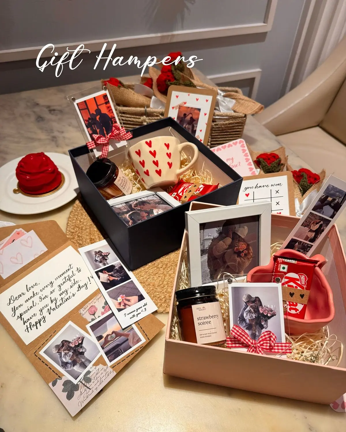Gift hampers on a table include photo frames, a heart-patterned mug, red roses, a candle, and sweet treats. The tone is romantic and thoughtful.