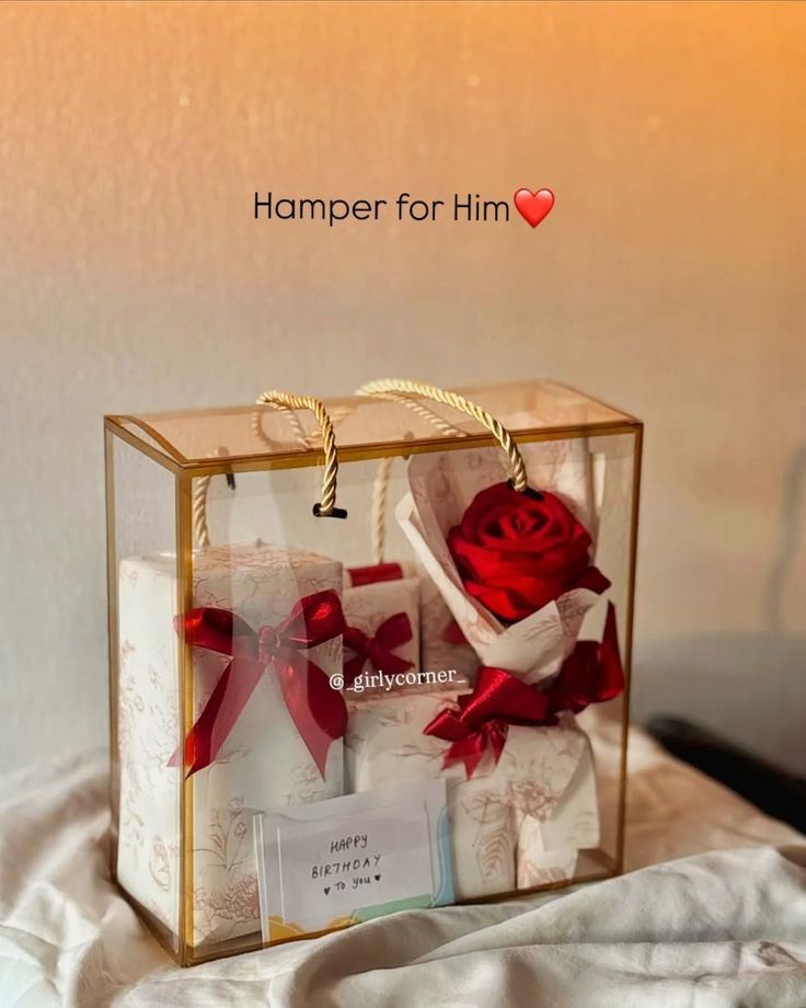 A gift hamper labeled "Hamper for Him" features elegantly wrapped items with red bows and a vibrant red rose, conveying a romantic and celebratory mood.